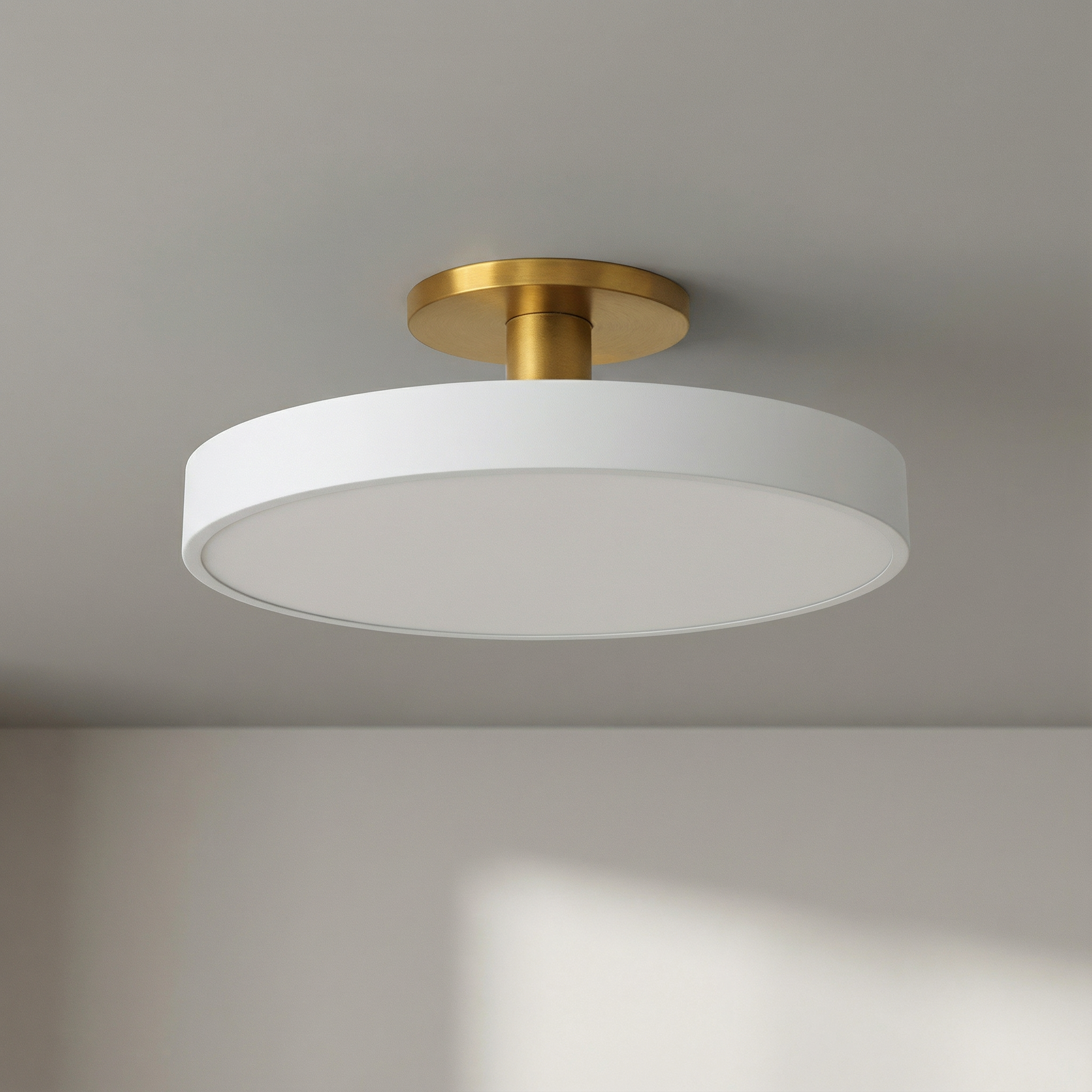 Ceiling light fixture with white shade and gold finish on a neutral background