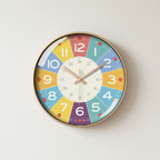 Colorful wall clock with a white face on a light gray background