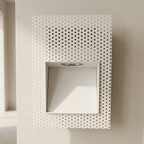 Decorative wall panel with circular perforations on a neutral background