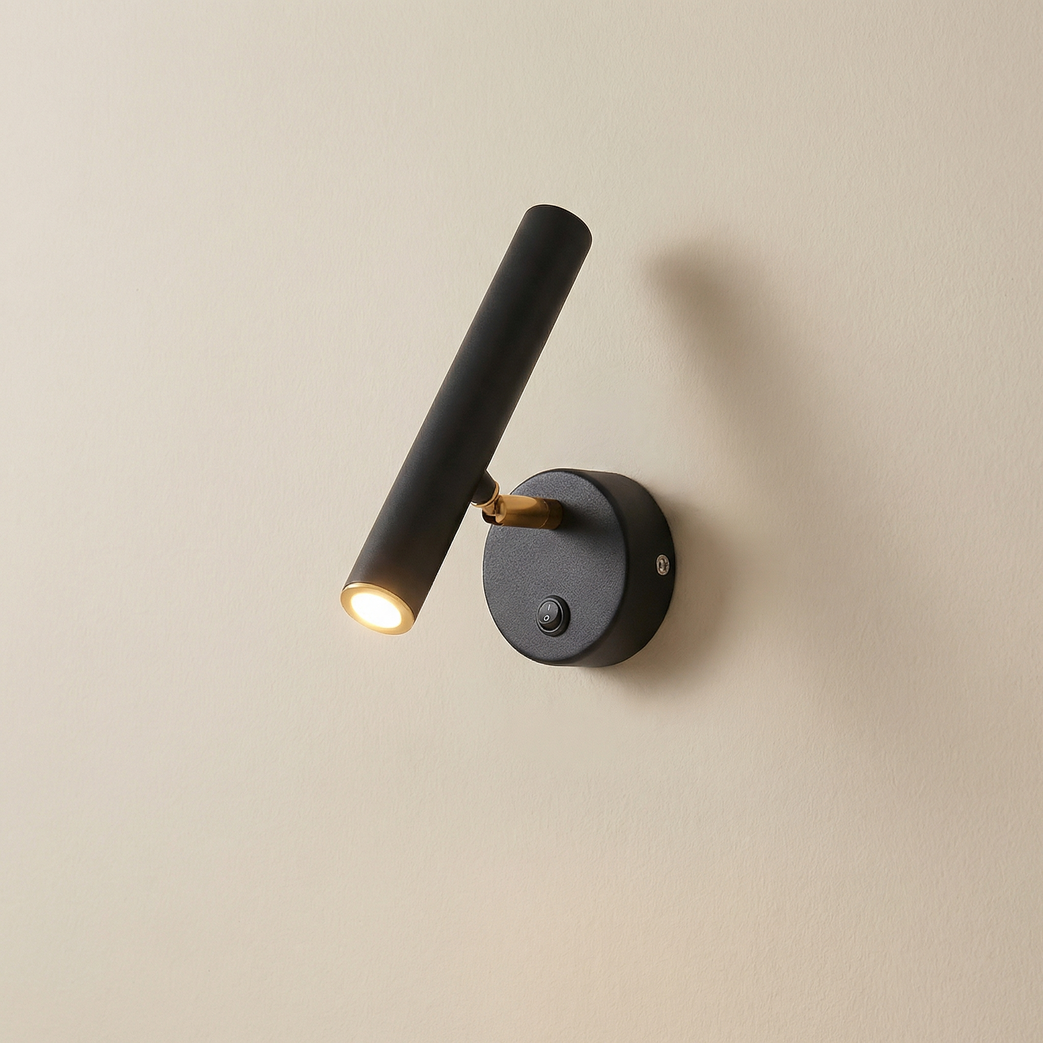 Modern wall-mounted light fixture on a beige wall