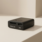 Black electronic device with Micro-SD and USB ports on a beige surface