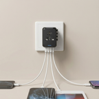 Black multi-port charger plugged into a wall socket with multiple devices charging.