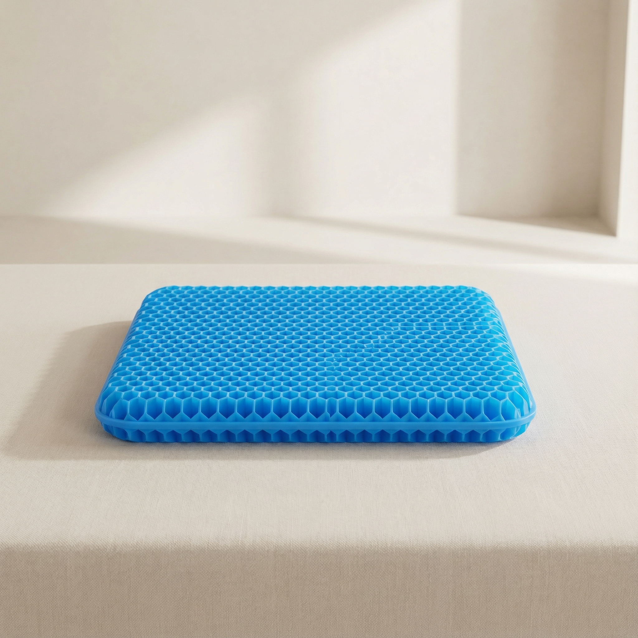 Blue honeycomb cushion on a beige surface