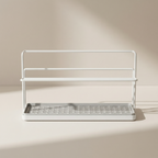 White metal dish rack with a tray on a beige background
