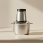 Stainless steel food chopper on a beige surface with a neutral background