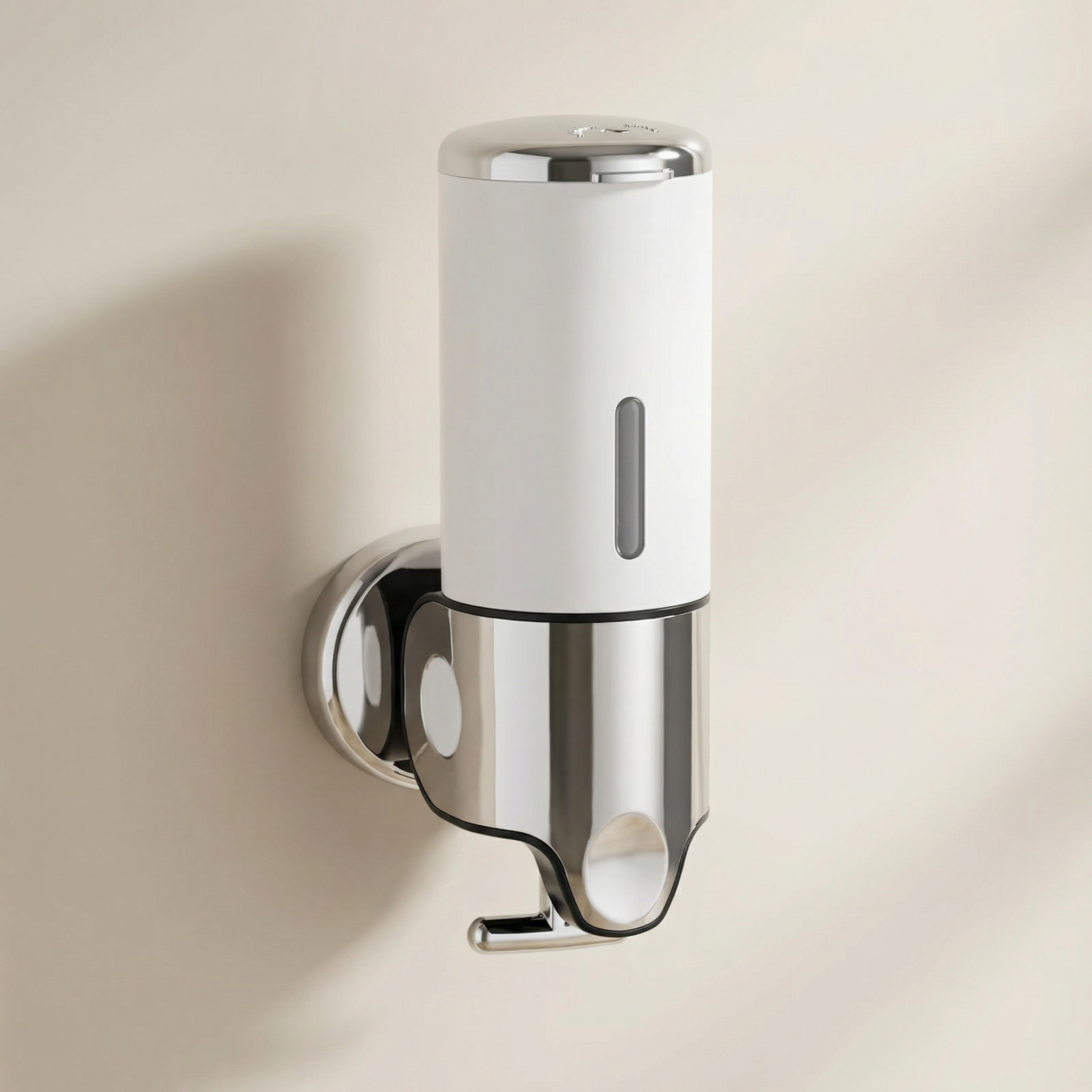 Wall-mounted soap dispenser with white and chrome finish on a beige wall.