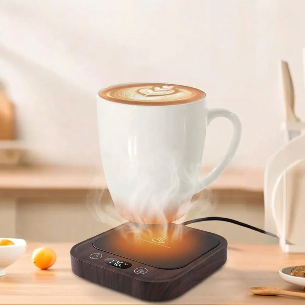 White mug with steaming coffee on a black electric warmer on a wooden table.