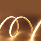 Coiled LED strip light on a dark background