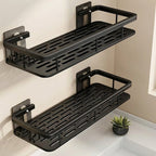 Two black wall-mounted shelves in a bathroom setting with a small plant.