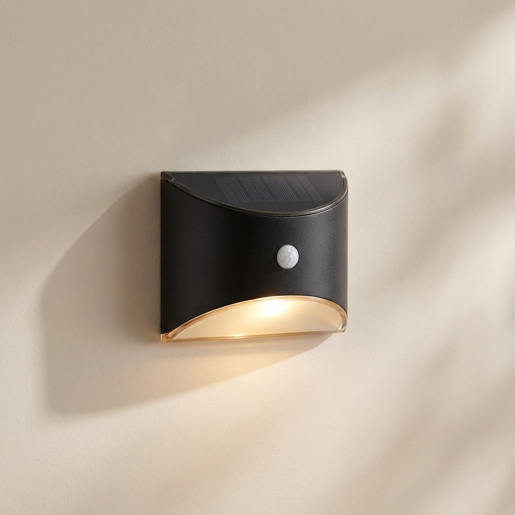 Black outdoor wall light fixture on a beige wall