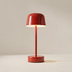 Red table lamp on a beige background