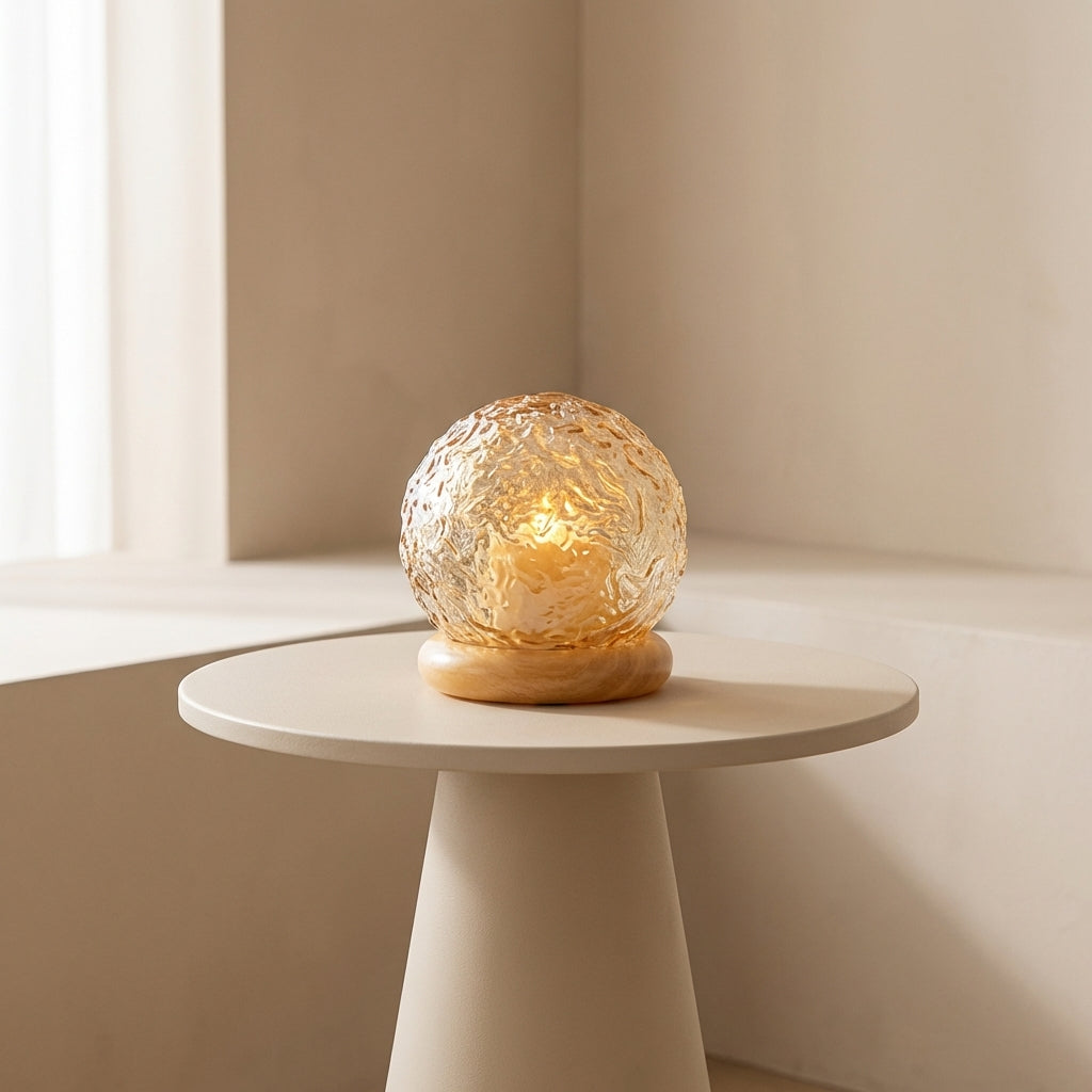 Decorative glass lamp on a small round table with a neutral background