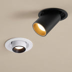 Two ceiling lights, one black and one white, on a beige background