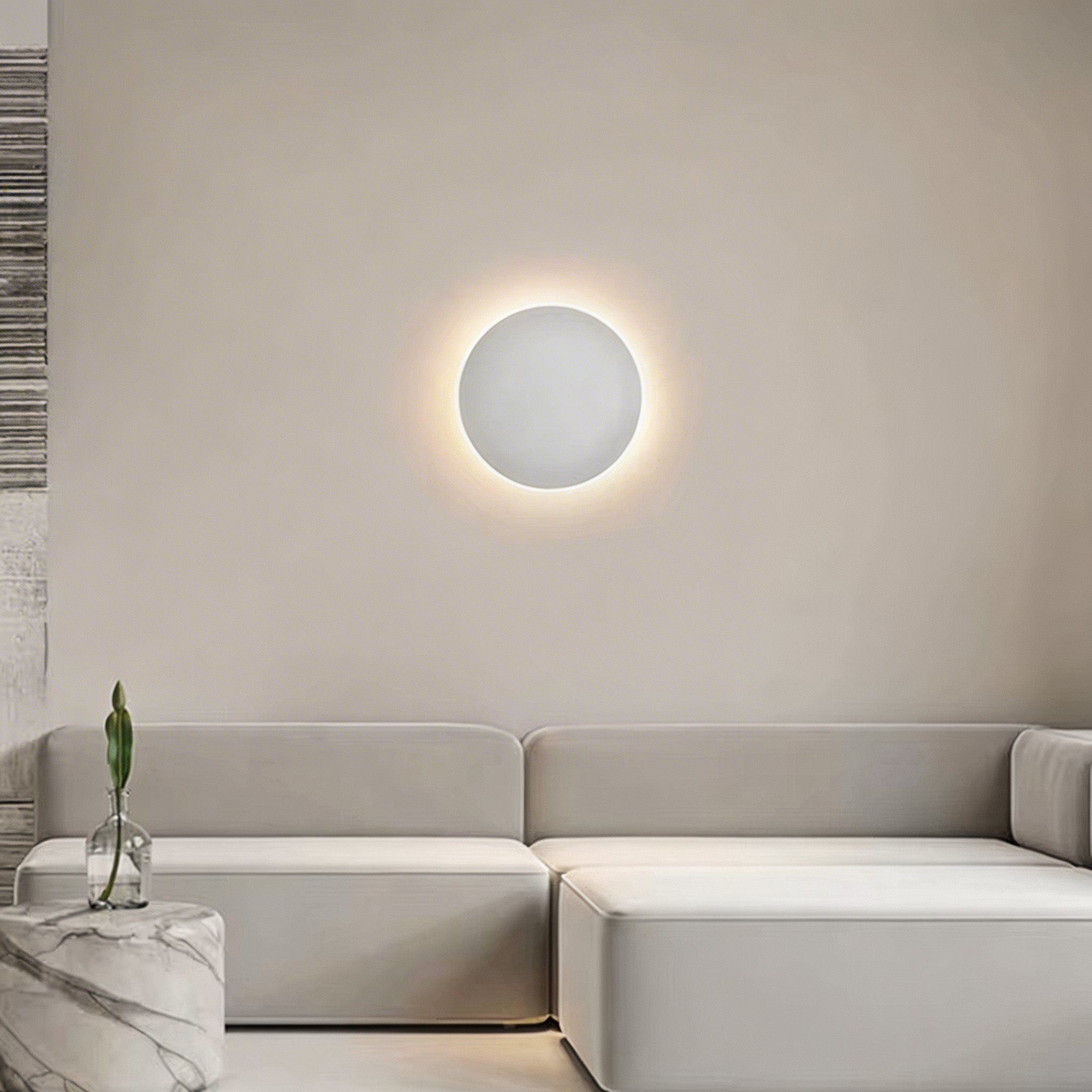 Modern living room with a round wall light fixture, gray sofa, and marble side table.