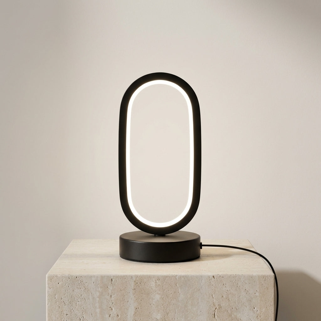 Modern black table lamp with circular design on a light gray background