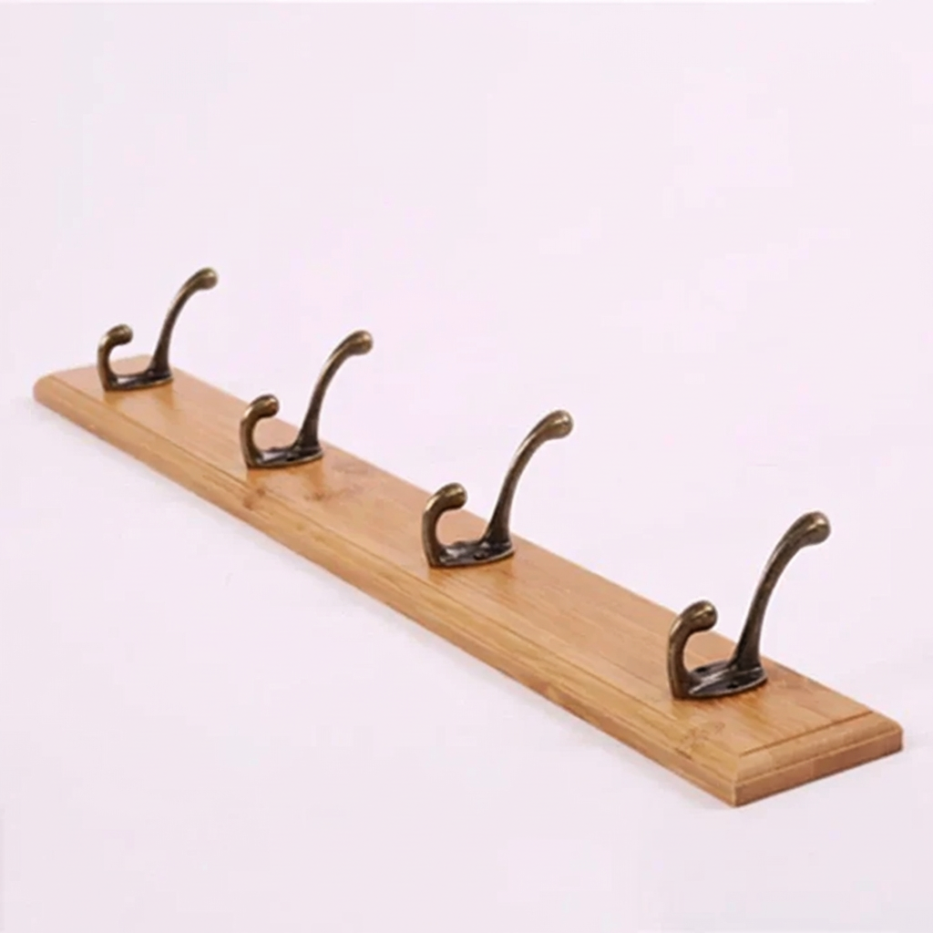 Wooden coat rack with five metal hooks on a white background