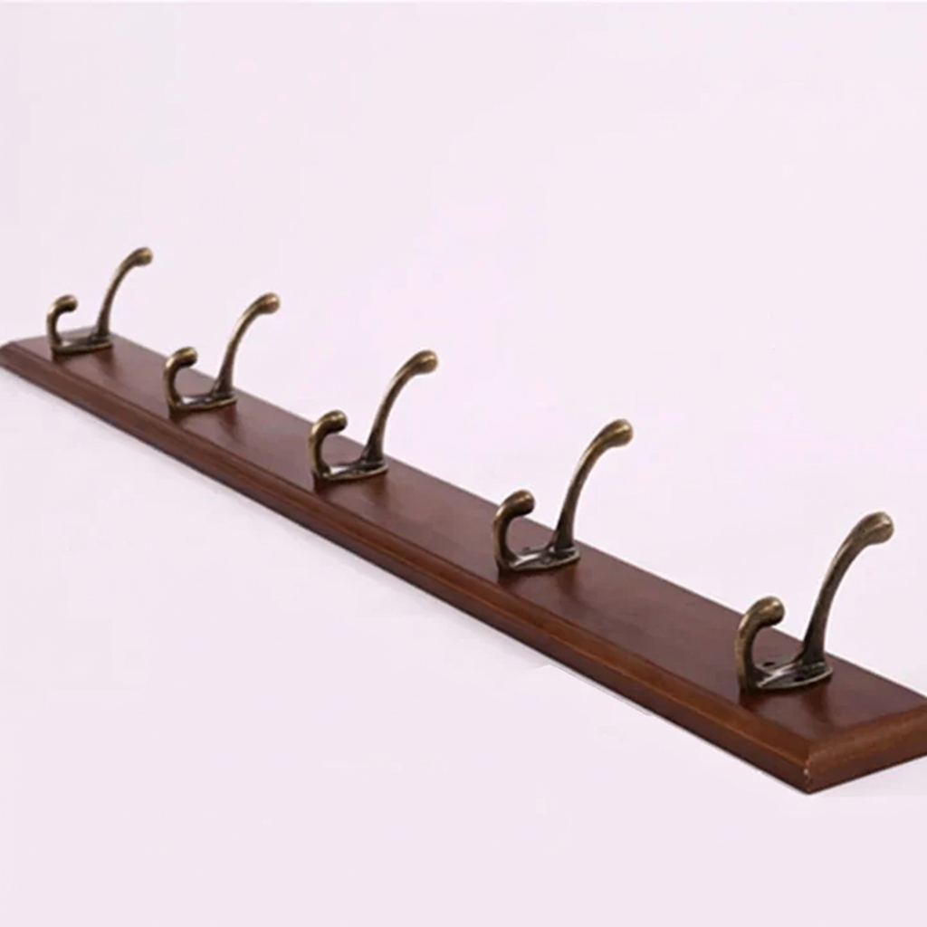 Wooden coat rack with five hooks on a white background