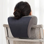 Person using a mesh back support pillow on a chair with a white background