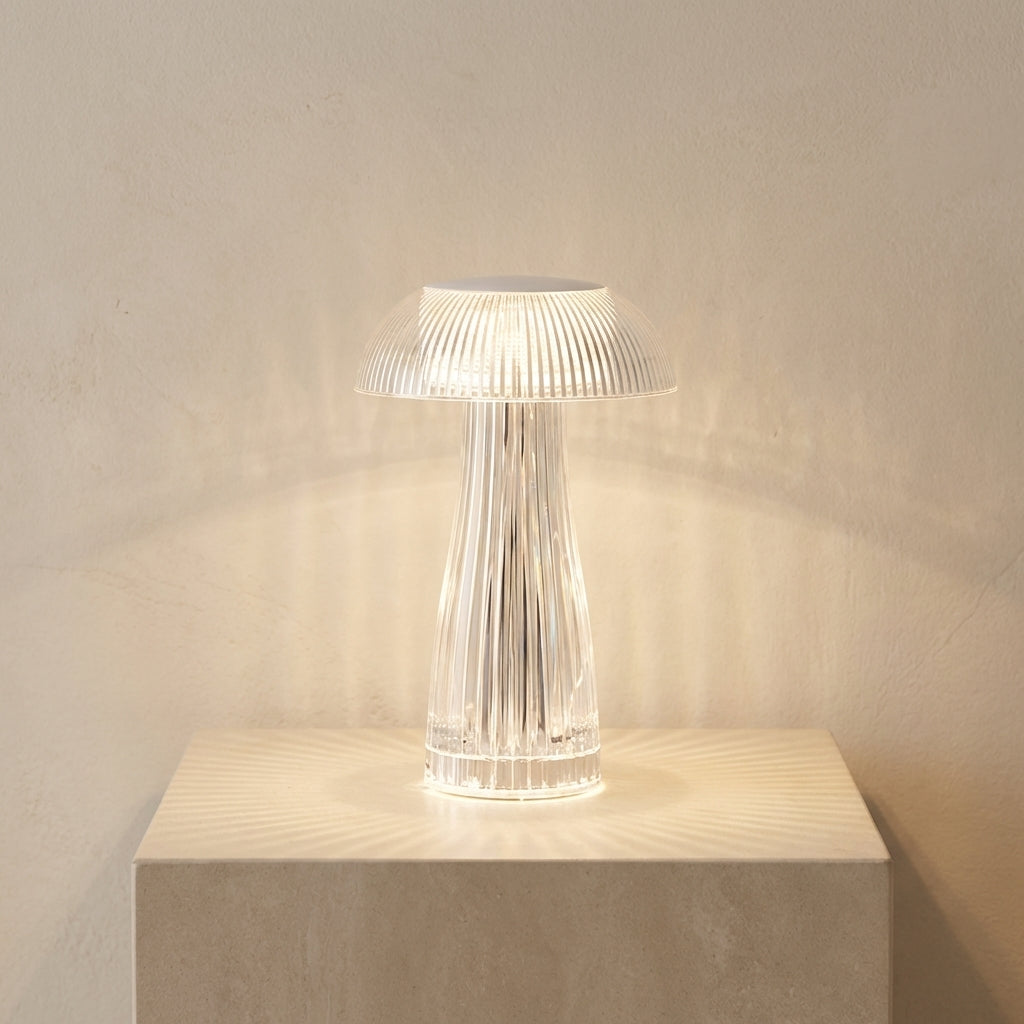Modern table lamp with ribbed design on a light surface against a neutral wall