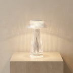Modern table lamp with ribbed design on a light surface against a neutral wall