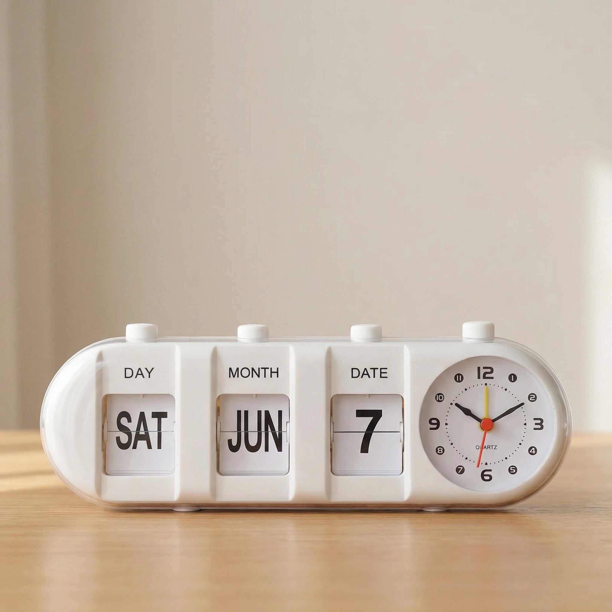 White clock with calendar display on a wooden surface