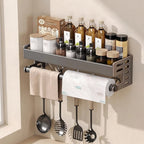 Kitchen wall-mounted rack with towels, paper towel roll, and various kitchen items.