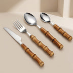 Set of cutlery with bamboo handles on a beige background