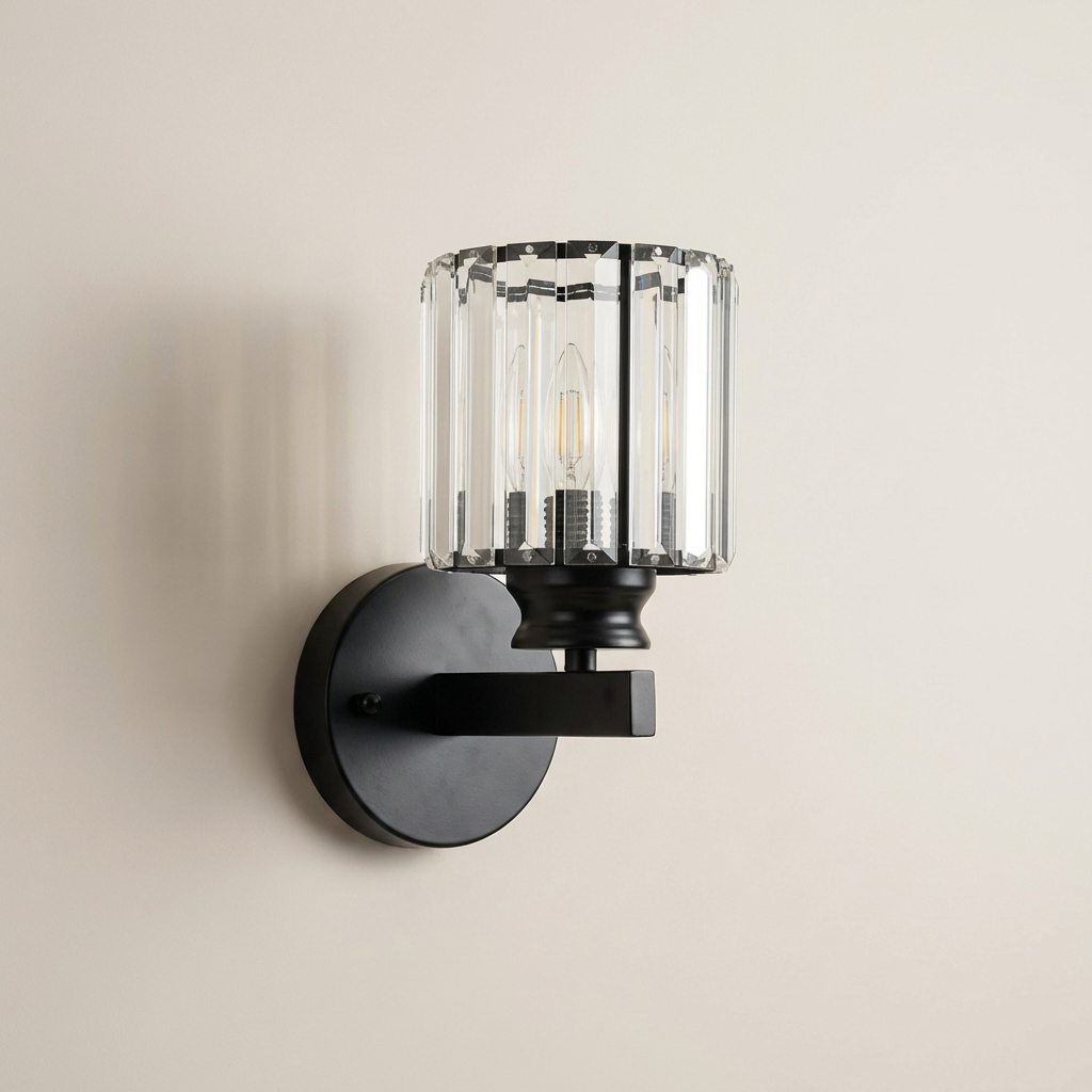 Black wall-mounted light fixture with clear glass shade on a beige wall.