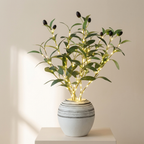 Decorative plant with lights in a white pot on a neutral background
