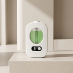 White and green electronic device on a light surface with a neutral background
