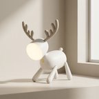 White deer-shaped lamp with a light bulb for a head on a neutral background