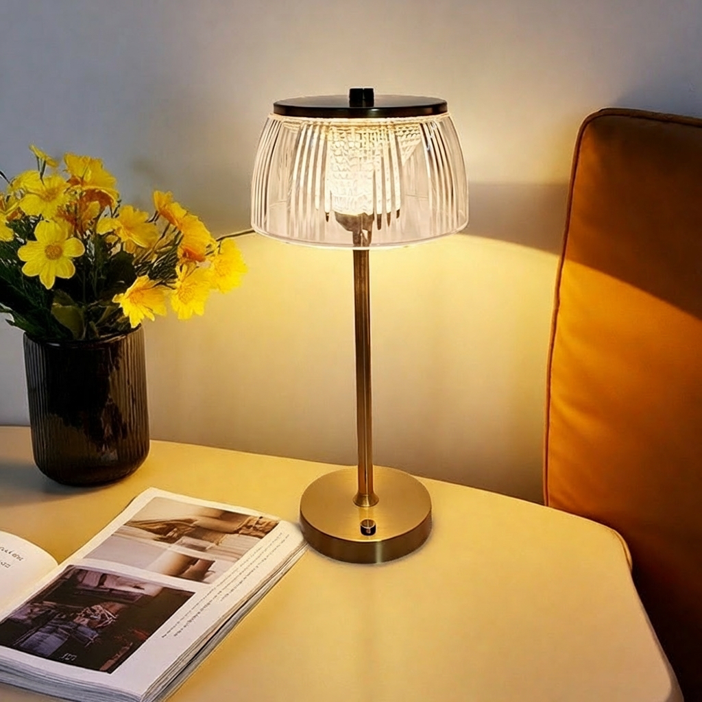 Table lamp on a table with a vase of yellow flowers and an open book in a cozy room setting.
