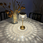 Table lamp casting shadows on a table with decorative elements.