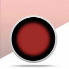 Close-up of a red circular object with a metallic rim on a pink and white background
