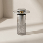 Metallic kitchen drain with mesh filter on a beige background