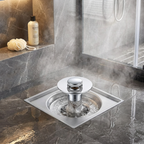 Square shower drain with water flowing in a tiled shower area.