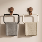 Two wall-mounted towel racks with wooden knobs holding gray towels against a beige background.