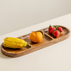 Wooden tray with a yellow vegetable, orange, and strawberries on a light background