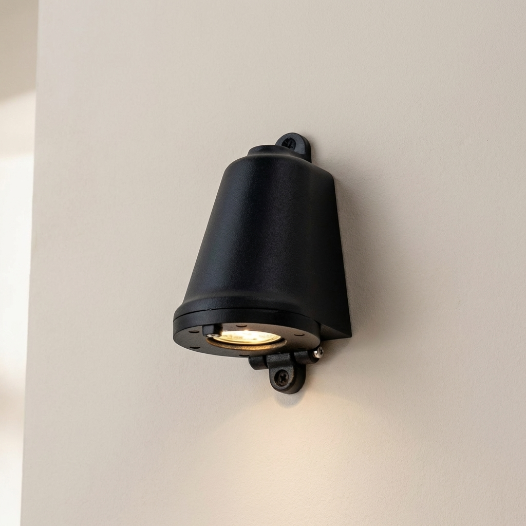 Black outdoor wall light fixture on a neutral wall