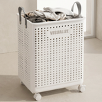 White laundry basket with perforated design and 'VISUALIZE' branding, filled with clothes on a neutral background.