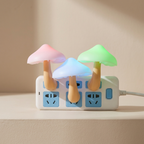 Colorful mushroom-shaped night lights attached to a power strip on a neutral background