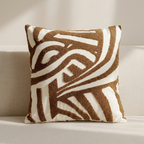 Decorative pillow with brown and white pattern on a neutral background