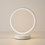 Modern table lamp with circular illuminated design on a neutral background