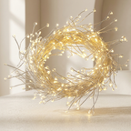 Decorative wreath with string lights on a neutral background