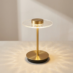 Gold table lamp with a modern design on a neutral background