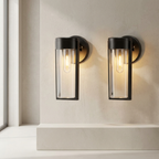 Two wall-mounted outdoor lights on a neutral wall.