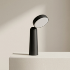 Modern black table lamp on a neutral background