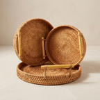 Woven rattan basket with lid on a neutral background
