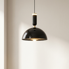 Modern black pendant light against a neutral background