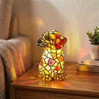 Stained glass dog lamp on a wooden surface with a cozy background